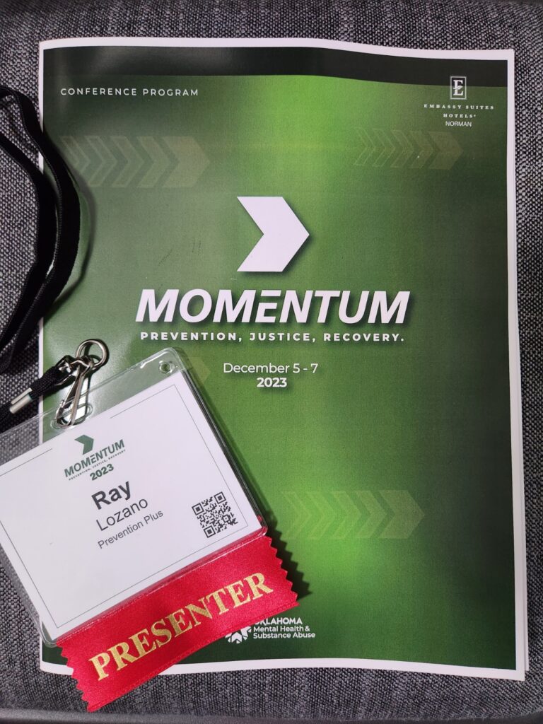 Photo of Momentum agenda with my name badge on it. 
