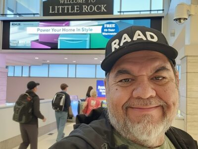 Ray Lozano smiling at Little Rock airport, capturing a travel moment before a drug prevention event