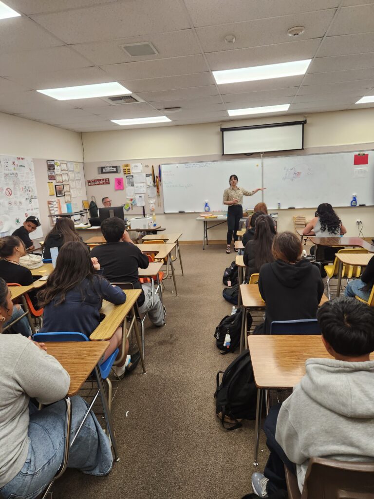 Dahlia Lozano teaching vaping information to high school students in a classroom.