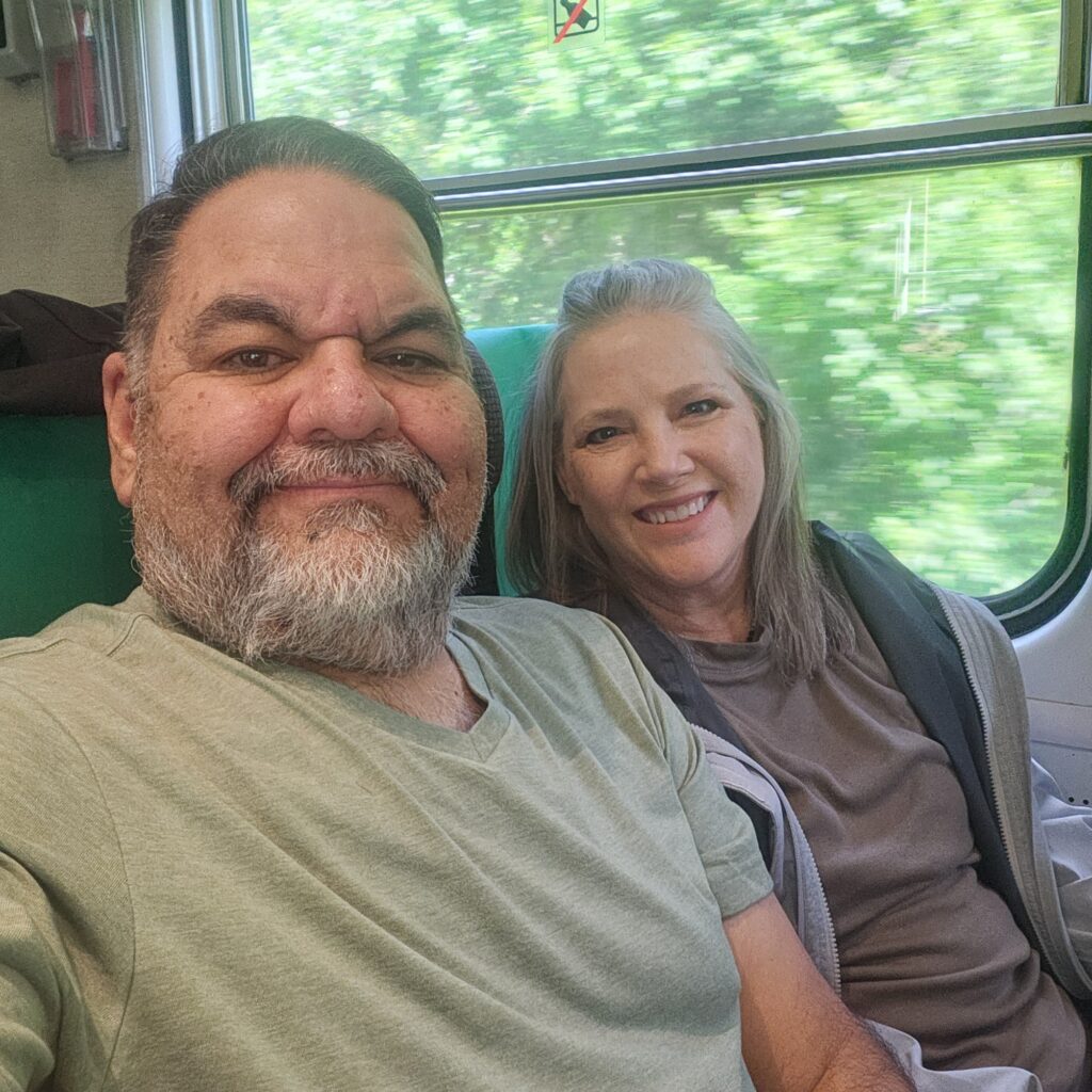 Ray Lozano and his wife riding a train on the way to a parent-teacher conference.