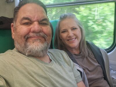 Ray Lozano and his wife riding a train on the way to a parent-teacher conference.