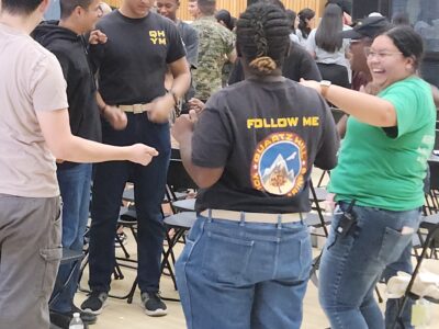 Students participating in an interactive youth drug-prevention activity led by Ray Lozano during a school workshop focused on peer influence and healthy decision-making