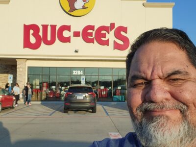 Ray Lozano standing outside a Buc-ee’s in Texas during a youth prevention speaking tour, preparing for a workshop at a nearby high school.