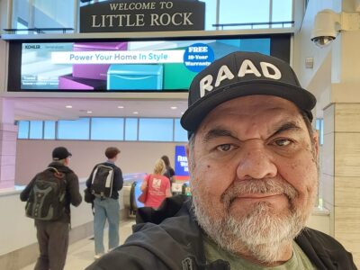 Ray Lozano standing inside the Little Rock airport while traveling to Arkansas for a community-based youth drug prevention event.