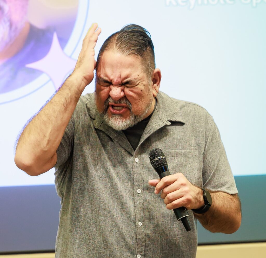 Professional youth prevention speaker using expressive body language while delivering an engaging school-based drug prevention presentation.